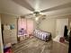 Charming bedroom with hardwood floors, ceiling fan, and pink sheer curtains at 408 South Farr Ave., Andrews, SC 29510