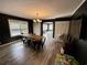 Bright dining room featuring a rustic wood table, laminate flooring, stylish light fixture, and view into another room at 408 South Farr Ave., Andrews, SC 29510