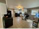 Well-lit kitchen features tiled floors, black appliances, white cabinets, a small island, and natural lighting from the window at 408 South Farr Ave., Andrews, SC 29510