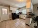 Bright and practical kitchen featuring white cabinetry, black appliances, and ceramic tile floor at 408 South Farr Ave., Andrews, SC 29510