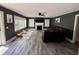 Inviting living room featuring a fireplace, ceiling fan, two large windows and sleek gray walls with a brown leather sofa at 408 South Farr Ave., Andrews, SC 29510