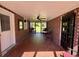 Enclosed porch with brick walls and ceiling fan; ideal for outdoor relaxation at 408 South Farr Ave., Andrews, SC 29510
