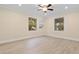 Bright bedroom with light wood floors, ceiling fan, and natural light from two windows at 409 14Th Ave. S, North Myrtle Beach, SC 29582
