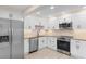 Modern kitchen with stainless steel appliances, shaker cabinets, granite countertops, and tile backsplash at 409 14Th Ave. S, North Myrtle Beach, SC 29582