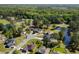 Scenic aerial view of a residential area with well-manicured lawns, a golf course, and a pond at 414 Staghorn Ln., Longs, SC 29568
