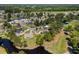 Aerial view showing the home's proximity to the golf course, lakes, and wooded landscape at 414 Staghorn Ln., Longs, SC 29568