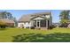 Exterior view of the home showing the large backyard and screened-in porch at 414 Staghorn Ln., Longs, SC 29568