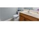 Bathroom featuring a toilet, sink with wood cabinets and neutral wall colors at 414 Staghorn Ln., Longs, SC 29568