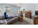 Bedroom featuring a ceiling fan and windows, plus access to an ensuite bathroom at 414 Staghorn Ln., Longs, SC 29568