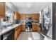 Kitchen features light-colored wooden cabinets, a stainless steel range and microwave, and stainless refrigerator at 414 Staghorn Ln., Longs, SC 29568