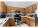 Kitchen features light-colored wooden cabinets, a stainless steel range and microwave, and stainless refrigerator at 414 Staghorn Ln., Longs, SC 29568
