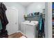 Efficient laundry room features a side-by-side washer and dryer, storage shelf, and room for hanging clothes at 414 Staghorn Ln., Longs, SC 29568