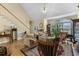 Light-filled living room with hardwood floors, stairs, neutral paint, and a large picture window at 414 Staghorn Ln., Longs, SC 29568