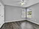 Bedroom with wood-look flooring, neutral walls, and natural light from the windows at 431 Brandymill Blvd, Myrtle Beach, SC 29588