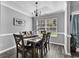 Formal dining room with wood-look floors, decorative chandelier, and a large window at 431 Brandymill Blvd, Myrtle Beach, SC 29588