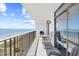 Relaxing balcony with comfortable seating offers breathtaking ocean views at 4311 S Ocean Blvd. # 701, North Myrtle Beach, SC 29582