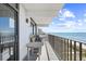 Scenic balcony view, complete with outdoor seating, overlooking the ocean and shoreline at 4311 S Ocean Blvd. # 701, North Myrtle Beach, SC 29582