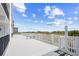 Spacious outdoor deck with white railings offering partial ocean views and a serene setting for relaxation at 4311 S Ocean Blvd. # 701, North Myrtle Beach, SC 29582