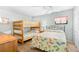 Cozy bedroom featuring a bunk bed, queen bed, ceiling fan, and charming decor at 4311 S Ocean Blvd. # 701, North Myrtle Beach, SC 29582