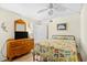 Comfortable bedroom with a ceiling fan, dresser, and a bed with patterned bedding at 4311 S Ocean Blvd. # 701, North Myrtle Beach, SC 29582
