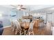 Dining space with hardwood floors connecting to a well-equipped kitchen and an ocean view balcony at 4311 S Ocean Blvd. # 701, North Myrtle Beach, SC 29582