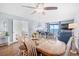 Warm dining area showcasing hardwood floors, a ceiling fan, and comfortable living space beyond at 4311 S Ocean Blvd. # 701, North Myrtle Beach, SC 29582