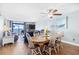 Dining room with hardwood floors, a ceiling fan, and a view of the ocean from the balcony at 4311 S Ocean Blvd. # 701, North Myrtle Beach, SC 29582