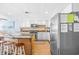 Spacious kitchen with a large island, stainless steel refrigerator, and bright white cabinetry at 4311 S Ocean Blvd. # 701, North Myrtle Beach, SC 29582