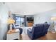 Comfortable living room with plush seating, hardwood floors, and a balcony overlooking the ocean at 4311 S Ocean Blvd. # 701, North Myrtle Beach, SC 29582