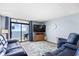 Cozy living room with hardwood floors, balcony access, and beautiful ocean views at 4311 S Ocean Blvd. # 701, North Myrtle Beach, SC 29582