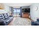 Charming living room featuring hardwood floors, a balcony, and ocean views at 4311 S Ocean Blvd. # 701, North Myrtle Beach, SC 29582