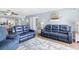 Open-concept living room featuring hardwood floors, access to a balcony, and plenty of seating at 4311 S Ocean Blvd. # 701, North Myrtle Beach, SC 29582