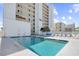 Large swimming pool with clear blue water next to a building with balconies and lounge chairs for relaxation at 4311 S Ocean Blvd. # 701, North Myrtle Beach, SC 29582