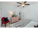 This bedroom features a ceiling fan, a window, and is comfortably furnished with a cozy comforter at 465 Tavistock Ct., Murrells Inlet, SC 29576