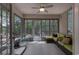 Relaxing sunroom with screened windows, comfortable seating, and serene outdoor views at 465 Tavistock Ct., Murrells Inlet, SC 29576
