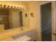 Well lit bathroom featuring a single sink vanity with light countertops and a large mirror at 5020 Windsor Green Way # 302, Myrtle Beach, SC 29579