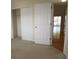 Bedroom with carpet, closet, and view into living area with sliding glass door at 5020 Windsor Green Way # 302, Myrtle Beach, SC 29579