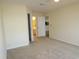 Carpeted bedroom with view to bathroom and partial view of kitchen at 5020 Windsor Green Way # 302, Myrtle Beach, SC 29579