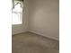 Empty bedroom with carpet, window, and light-colored walls at 5020 Windsor Green Way # 302, Myrtle Beach, SC 29579