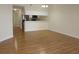 View of kitchen appliances and breakfast bar from hardwood floored living room at 5020 Windsor Green Way # 302, Myrtle Beach, SC 29579