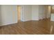 Spacious living room with hardwood floors, neutral walls, and multiple doorways at 5020 Windsor Green Way # 302, Myrtle Beach, SC 29579