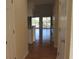 Hallway leading to open living area with sliding glass doors to balcony and hardwood floors at 5020 Windsor Green Way # 302, Myrtle Beach, SC 29579