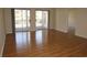 Bright living room with sliding glass doors to balcony and gleaming hardwood floors at 5020 Windsor Green Way # 302, Myrtle Beach, SC 29579