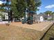 Community playground with slide and climbing structure surrounded by green trees at 5020 Windsor Green Way # 302, Myrtle Beach, SC 29579