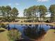 Scenic pond view with lush trees reflecting in the calm water at 5020 Windsor Green Way # 302, Myrtle Beach, SC 29579