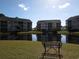 Community pond surrounded by well-maintained buildings on a sunny day at 5020 Windsor Green Way # 302, Myrtle Beach, SC 29579