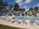 Relaxing pool area featuring lounge chairs, umbrellas, and palm trees at 5020 Windsor Green Way # 302, Myrtle Beach, SC 29579