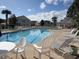 Community swimming pool with ample seating and clear blue water at 5020 Windsor Green Way # 302, Myrtle Beach, SC 29579