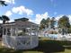 Community pool with seating around it and a gazebo with views of the surrounding area at 5020 Windsor Green Way # 302, Myrtle Beach, SC 29579