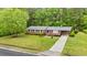 Aerial view of the brick home with a well-kept lawn and beautiful landscaping at 5033 Brantwood Dr., Mullins, SC 29574